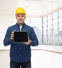 Image showing smiling male builder in helmet with tablet pc
