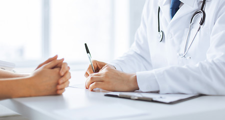 Image showing patient and doctor taking notes