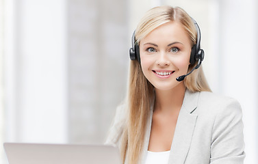 Image showing friendly female helpline operator with laptop