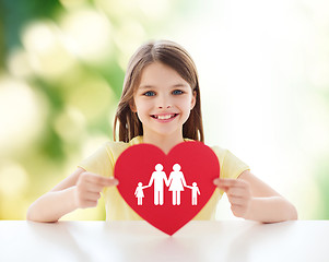 Image showing beautiful little girl sitting at table