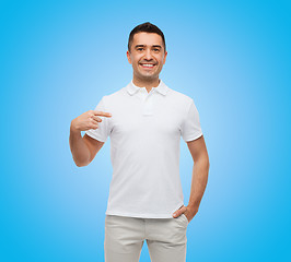 Image showing smiling man in t-shirt pointing finger on himself