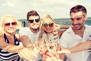 Image showing smiling friends with glasses of champagne on yacht