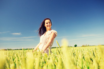 Image showing smiling young woman on cereal field