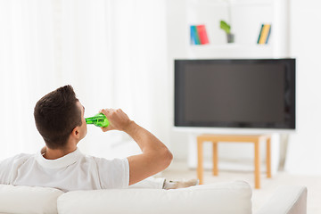 Image showing man watching tv and drinking beer at home