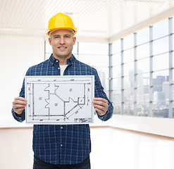 Image showing smiling male builder in helmet with blueprint