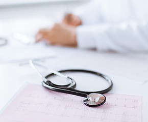 Image showing male doctor hands with cardiogram