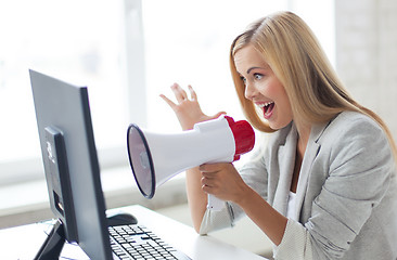 Image showing crazy businesswoman shouting in megaphone