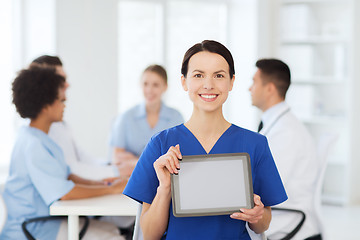 Image showing happy doctor over group of medics at hospital