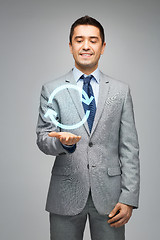 Image showing happy businessman in suit showing circle arrow
