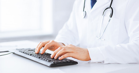 Image showing male doctor typing  on the keyboard