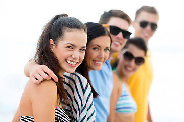 Image showing group of happy friends on beach