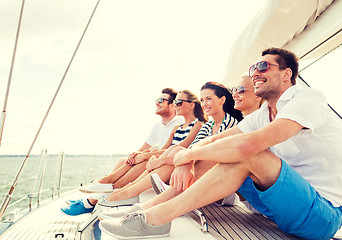 Image showing smiling friends sitting on yacht deck