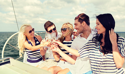 Image showing smiling friends with glasses of champagne on yacht