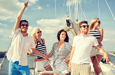 Image showing smiling friends sailing on yacht