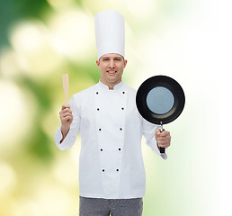 Image showing happy male chef holding frying pan and spatula