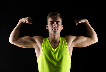 Image showing young man showing biceps