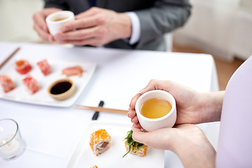 Image showing close up of couple drinking tea at restaurant