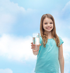 Image showing smiling little girl giving glass of water