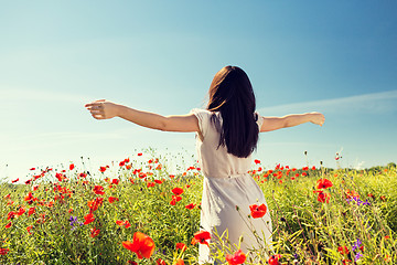 Image showing young woman on poppy field