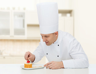 Image showing happy male chef cook decorating dessert