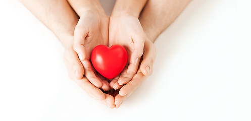 Image showing couple hands holding red heart