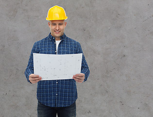 Image showing smiling male builder in helmet with blueprint