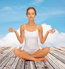 Image showing woman  meditating in yoga lotus pose