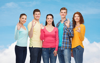 Image showing group of smiling teenagers showing ok sign