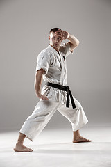 Image showing Man in white kimono training karate