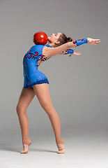 Image showing teenager doing gymnastics exercises with red gymnastic ball