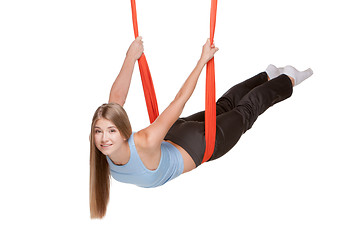 Image showing Young woman doing anti-gravity aerial yoga