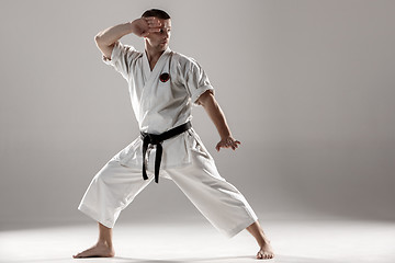 Image showing Man in white kimono training karate