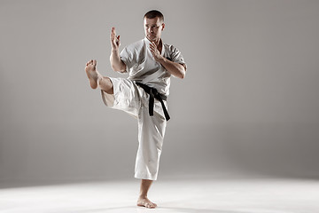 Image showing Man in white kimono training karate