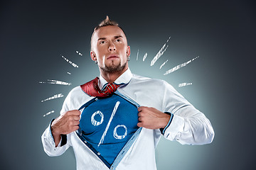 Image showing businessman acting like a super hero and tearing his shirt off