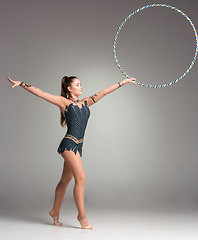 Image showing teenager doing gymnastics exercises with colorful hoop