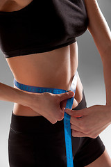 Image showing Fit and healthy waist measured with a tape 