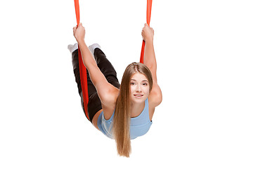 Image showing Young woman doing anti-gravity aerial yoga
