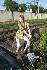 Image showing Pretty girl throws railway switch