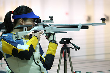 Image showing woman aiming a pneumatic air rifle