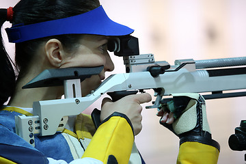 Image showing woman aiming a pneumatic air rifle