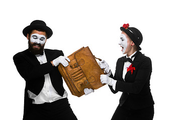 Image showing Business man and woman fighting over briefcase