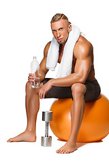 Image showing Shaped and healthy body man sitting on fitness ball 