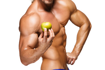 Image showing Shaped and healthy body man holding a fresh apple fruit,  isolated on white background