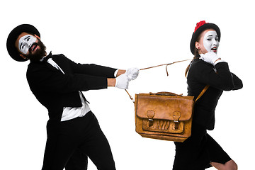 Image showing Business man and woman fighting over briefcase