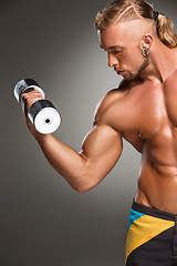 Image showing Attractive male body builder on gray background