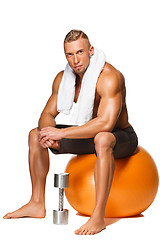 Image showing Shaped and healthy body man sitting on fitness ball 