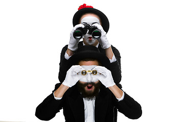 Image showing Two memes as business people looking through binoculars 