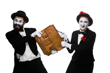 Image showing Business man and woman fighting over briefcase