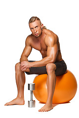 Image showing Shaped and healthy body man sitting on fitness ball 