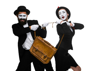 Image showing Business man and woman fighting over briefcase